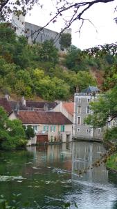 a view of a river with houses and buildings at Gite en Forterre in Druyes-les-Belles-Fontaines