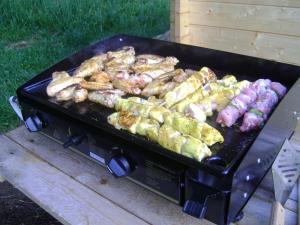 a grill with many different types of food on it at La Yourte Un Autre Monde in Le Hohwald