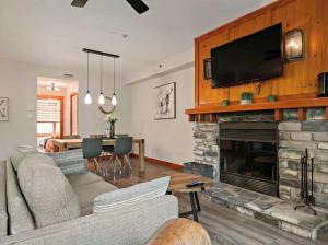 a living room with a couch and a fireplace at Tremblant Les Eaux by Rendez-Vous Mont-Tremblant in Mont-Tremblant