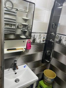 a small bathroom with a sink and a mirror at Chimino in Sétif +7 photos