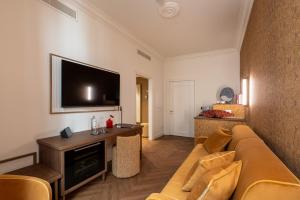 a living room with a couch and a flat screen tv at Hotel San Samuele in Venice +24 photos