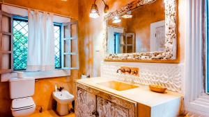 a bathroom with a sink and a toilet and a mirror at Villa Amani in Malindi +121 photos