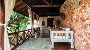 a room with a stone wall and a chair on a porch at Villa Amani in Malindi