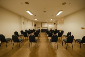 an empty room with chairs and a podium in it at San Agustin El Dorado in Cusco