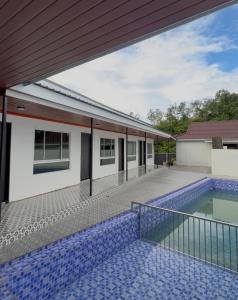 an external view of a house with a swimming pool at Chalet Gunung Stong in Dabung
