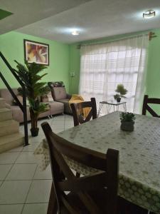 a living room with a table and a couch at Casa de los Sauces in Toluca
