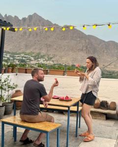 a man and a woman eating food at a table at Khachats Toun Heritage in Meghri
