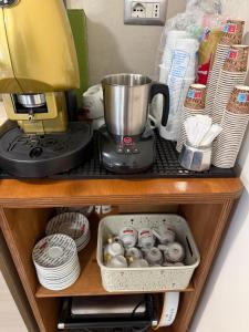 a kitchen shelf with a blender and a mixer at CasaMamy Residence in Pompei