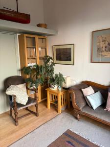 a living room with a couch and a potted plant at River Garden View in Beccles +19 photos