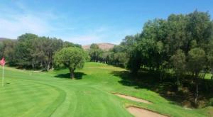 a view of a golf course with trees in the background at Beautiful Apartment Executive 3 in Guadalupe