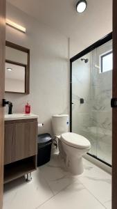 a bathroom with a toilet and a glass shower at Casa completa de fin de semana Cuautla in Tlayecac +34 photos