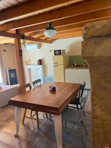 a dining room with a wooden table and chairs at La Alcoba de los Cuentos in Urueña +8 photos