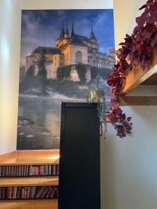 a large painting of a castle on a wall at La Alcoba de los Cuentos in Urueña