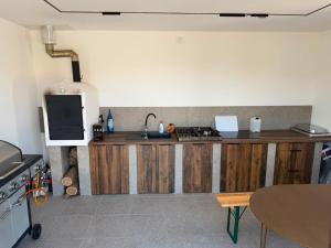 a kitchen with a wooden counter with a sink at Mély-Patak Vendégház in Erdőbénye +5 photos