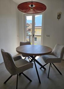 a table and chairs in a room with a window at Fischerhof in Cortaccia