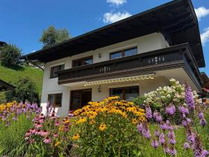 a building with a bunch of flowers in front of it at Chalet Veronika in Fieberbrunn