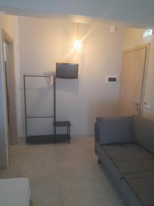a living room with a couch and a light at Giotis Apartments in Plataria