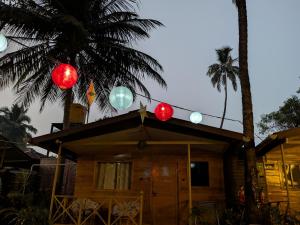 a house with christmas lights on top of it at WOODMOOD Cottages in Chapora