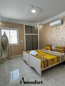 a bedroom with a large bed in a room at Sablette mostaganem in Les Sablettes Mazagran-Plage