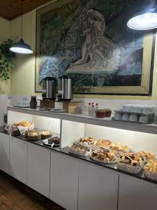 a buffet line with many different types of pastries at Hotel Planalto in Poços de Caldas