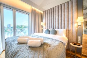 a bedroom with a large bed with a large window at Lake Rental Inpro 89 in Mikołajki