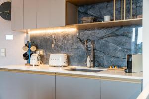a kitchen with a sink and a counter top at Lake Rental Inpro 89 in Mikołajki +22 photos