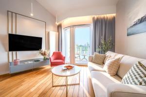 a living room with a white couch and a tv at Lake Rental Inpro 89 in Mikołajki