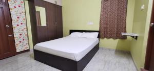 a bedroom with a bed in a room at Carmel Stay in Madurai