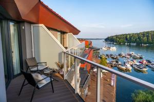 a balcony with a view of a marina at Lake Rental Inpro 89 in Mikołajki