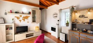 a living room with a tv and a couch at Azores Panorama Lodge in Norte Pequeno