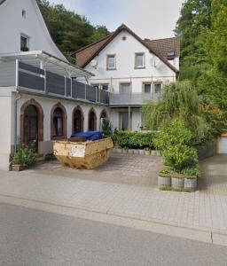 a large white house with a large building at Alex' Apartments Waldharmonie in Bad Bergzabern