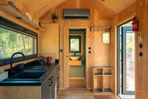 a kitchen in a tiny house with a sink at OtuliLas - Tiny House in Komarno