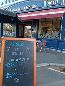 a chalkboard sign in front of a hotel at Hôtel-Brasserie du marché in Saint-Pierre-du-Regard