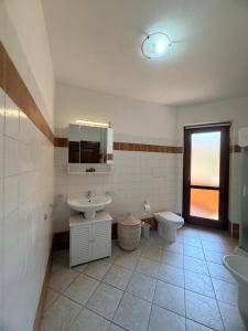 a bathroom with a sink and a toilet at La Terrazza sul Golfo in Golfo Aranci +45 photos
