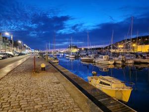 a group of boats docked in a marina at night at Cap Ouest in Fécamp
