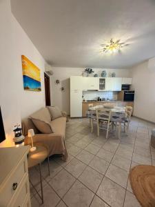 a living room with a couch and a table at La Terrazza sul Golfo in Golfo Aranci