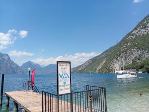 a sign on a dock in the water with a boat at Villa Monica in Malcesine