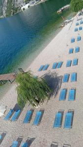 an overhead view of a beach with chairs and the water at Villa Monica in Malcesine