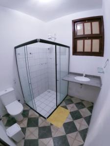 a bathroom with a shower and a toilet and a sink at Pajuçara Inn - Pousada Maceió in Maceió +11 photos