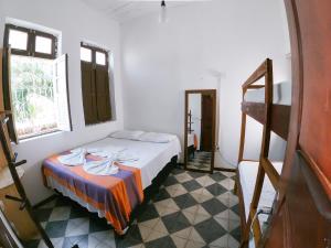 a bedroom with a bed and a staircase in it at Pajuçara Inn - Pousada Maceió in Maceió
