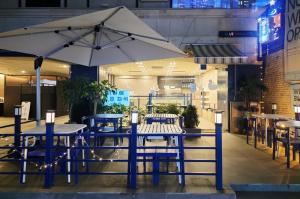 a restaurant with tables and chairs and an umbrella at Blueduck hotel in Seoul
