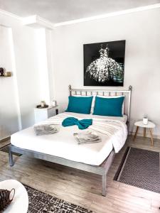 a bedroom with a large bed with blue pillows at Smile studio in Drama