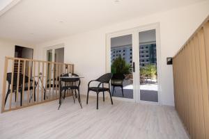 a balcony with chairs and a table on a balcony at Otti Hotel in Vlorë