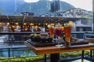 a tray of drinks on a table on a balcony at Casa Tungurahua in Baños