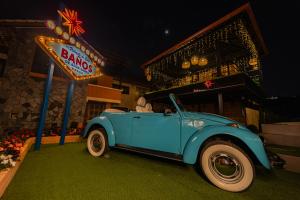 an old blue car parked in front of a bar at Casa Tungurahua in Baños