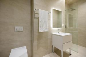 a bathroom with a white sink and a shower at Otti Hotel in Vlorë +239 photos