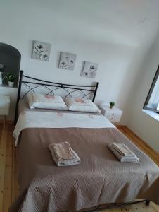 a bedroom with a bed with two towels on it at Mastic lithos house in Chios