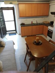 a kitchen with a wooden table and a dining room at Mastic lithos house in Chios +22 photos