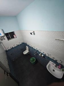 a bathroom with a sink and a toilet at The Reset House Mangalore in Mangalore