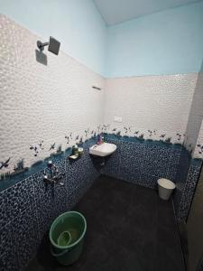 a blue and white bathroom with a sink and a toilet at The Reset House Mangalore in Mangalore